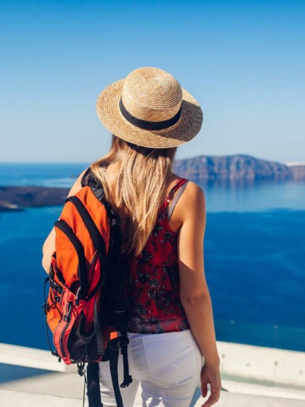 woman-traveler-looking-caldera-from-fira-thera-santorini-island-greece-tourism-traveling-vacation-concept